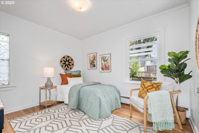 bedroom featuring crown molding, multiple windows, and a baseboard radiator