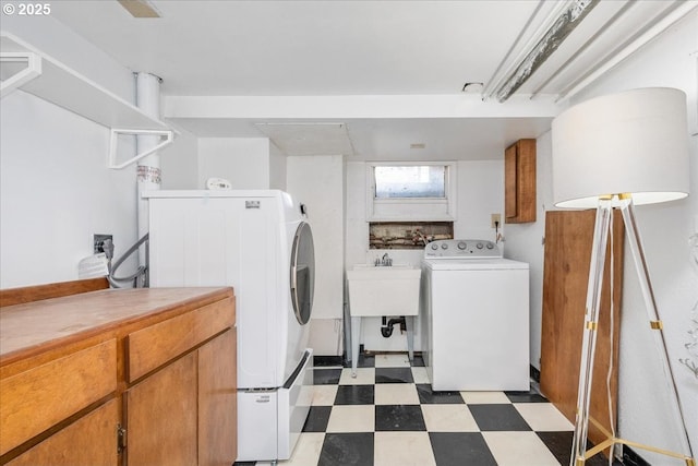 laundry area featuring washer / dryer, cabinet space, tile patterned floors, and a sink