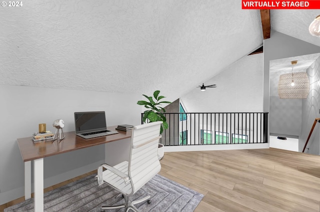 office area with a ceiling fan, lofted ceiling with beams, a textured ceiling, and wood finished floors