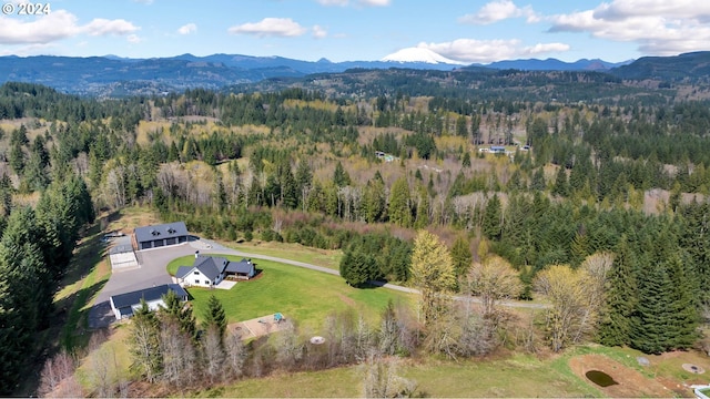 aerial view with a mountain view and a wooded view