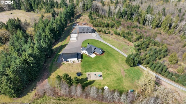 birds eye view of property with a wooded view