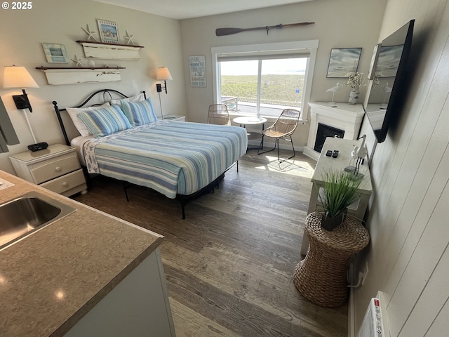 1022 N Prom, Seaside, OR 97138 - bedroom featuring dark wood-type flooring and a fireplace