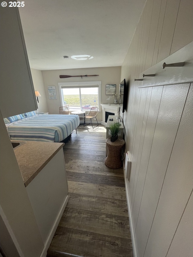 1022 N Prom, Seaside, OR 97138 - bedroom featuring dark wood-style floors and a fireplace