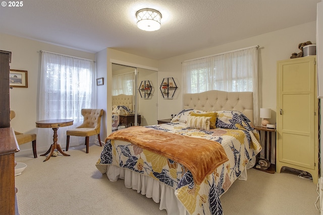 9403 SW 74th Ave, Portland, OR 97223 - bedroom with light carpet, multiple windows, a closet, and a textured ceiling