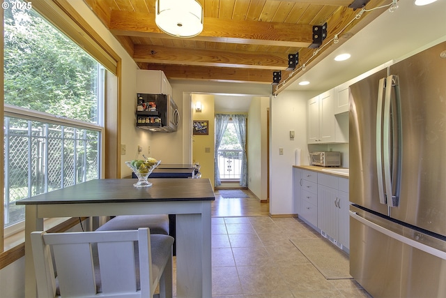 9403 SW 74th Ave, Portland, OR 97223 - kitchen with freestanding refrigerator, white cabinetry, a wood ceiling with exposed beams, light tile patterned floors, and recessed lighting