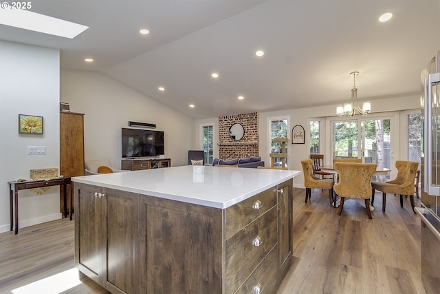 9403 SW 74th Ave, Portland, OR 97223 - kitchen with a center island, light wood-style floors, recessed lighting, light countertops, and vaulted ceiling