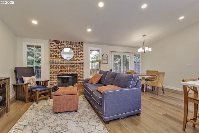 9403 SW 74th Ave, Portland, OR 97223 - living room with wood finished floors, a chandelier, recessed lighting, lofted ceiling, and a brick fireplace