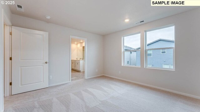 2124 NE 3rd Ave, Battle Ground, WA 98604 - unfurnished bedroom featuring light carpet, baseboards, visible vents, and ensuite bath
