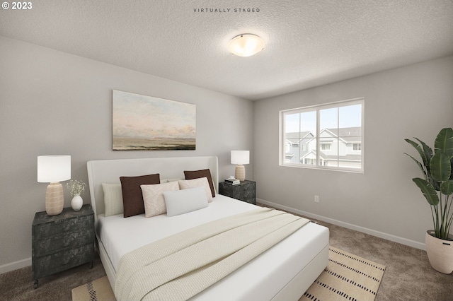 carpeted bedroom featuring a textured ceiling