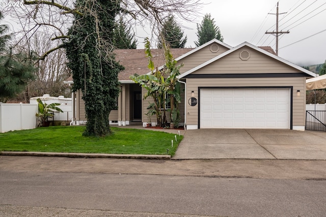 view of front of property with a garage and a front yard