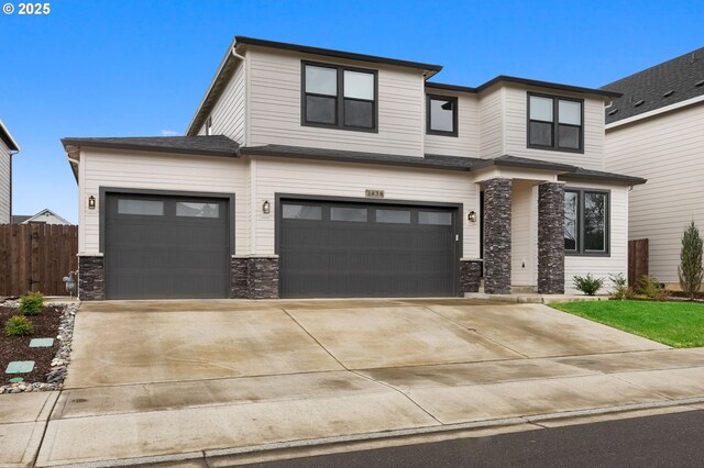 3838 SE 7th Ave, Battle Ground, WA 98604 - view of front of home with concrete driveway, an attached garage, and stone siding
