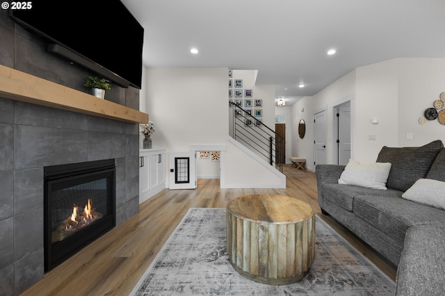 3838 SE 7th Ave, Battle Ground, WA 98604 - living room featuring a tiled fireplace, wood finished floors, stairs, and recessed lighting