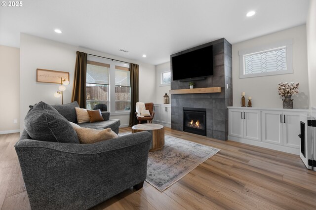 3838 SE 7th Ave, Battle Ground, WA 98604 - living area featuring a tiled fireplace, light wood-style floors, recessed lighting, and baseboards