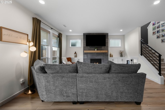 3838 SE 7th Ave, Battle Ground, WA 98604 - living room featuring a tiled fireplace, stairway, wood finished floors, baseboards, and recessed lighting