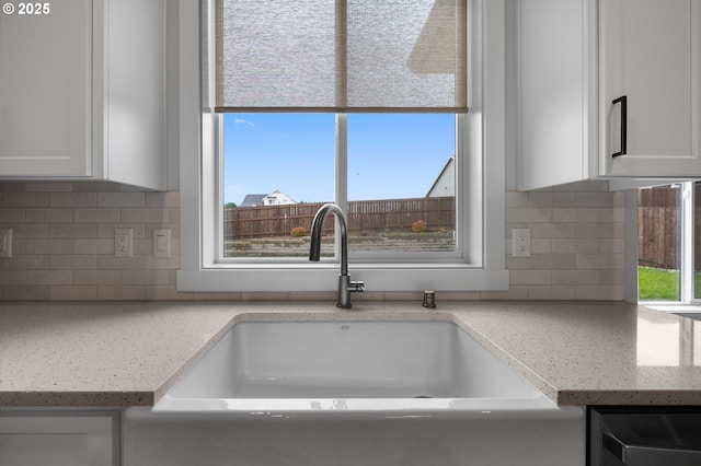 3838 SE 7th Ave, Battle Ground, WA 98604 - kitchen view of a sink, white cabinets, dishwashing machine, and tasteful backsplash