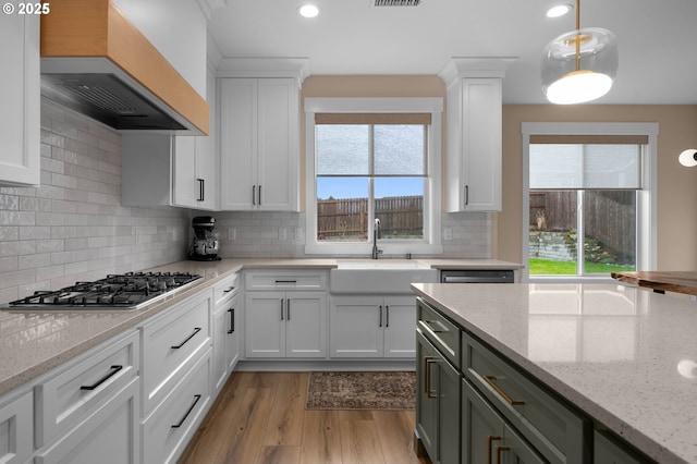 3838 SE 7th Ave, Battle Ground, WA 98604 - kitchen with premium range hood, a sink, stainless steel gas stovetop, light wood-type flooring, and plenty of natural light