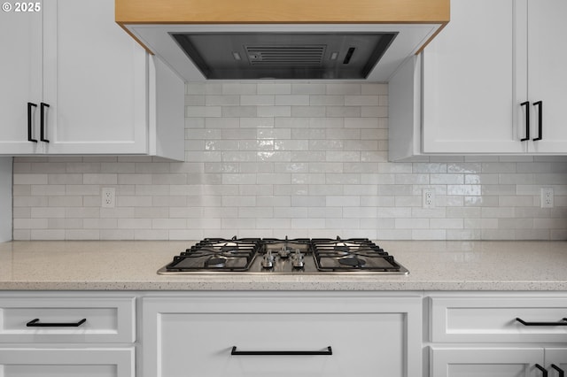 3838 SE 7th Ave, Battle Ground, WA 98604 - kitchen featuring stainless steel gas cooktop, range hood, white cabinets, and tasteful backsplash
