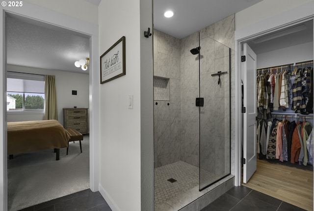 3838 SE 7th Ave, Battle Ground, WA 98604 - full bath featuring a shower stall, tile patterned flooring, a spacious closet, baseboards, and recessed lighting