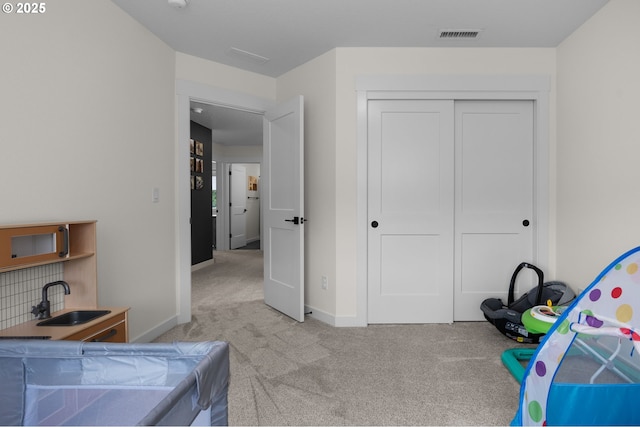 3838 SE 7th Ave, Battle Ground, WA 98604 - bedroom with light colored carpet, a sink, baseboards, and a closet