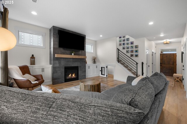 3838 SE 7th Ave, Battle Ground, WA 98604 - living room with stairway, a tiled fireplace, light wood-style floors, and recessed lighting