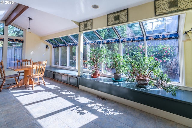 sunroom / solarium with visible vents and beamed ceiling