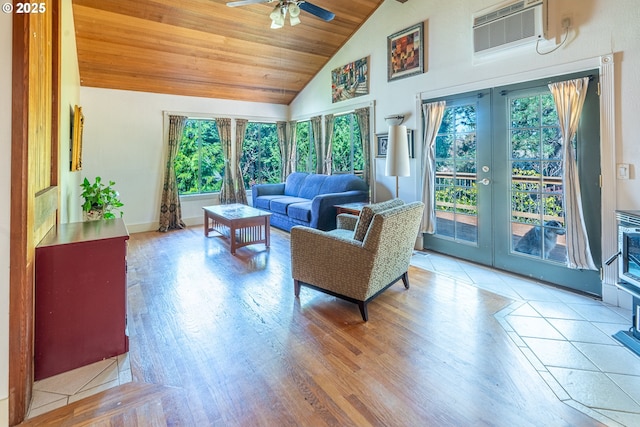 living room featuring ceiling fan, french doors, a wall mounted AC, wood finished floors, and high vaulted ceiling
