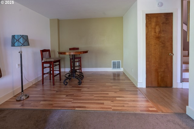 interior space with visible vents, wood finished floors, and baseboards