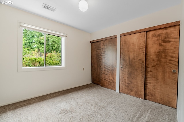19686 Sun Cir, West Linn, OR 97068 - unfurnished bedroom with two closets, carpet, and baseboards