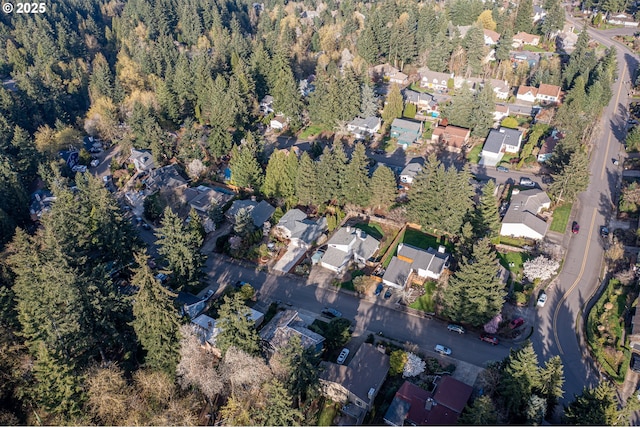drone / aerial view with a residential view and a view of trees