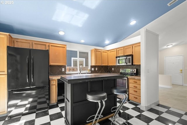 kitchen featuring black appliances, light floors, backsplash, a sink, and recessed lighting