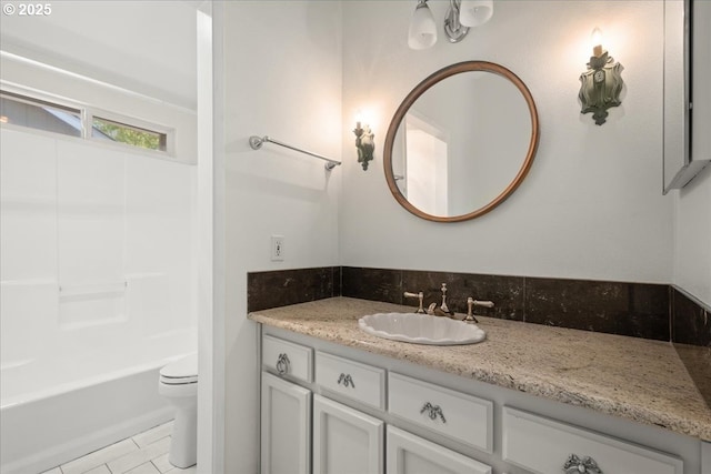 bathroom with vanity, tile patterned flooring, toilet, and shower / bathtub combination
