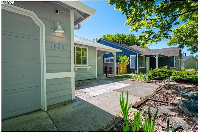 back of property featuring a shingled roof
