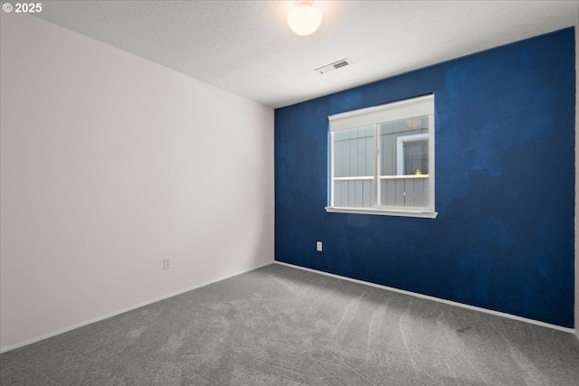 carpeted empty room with baseboards