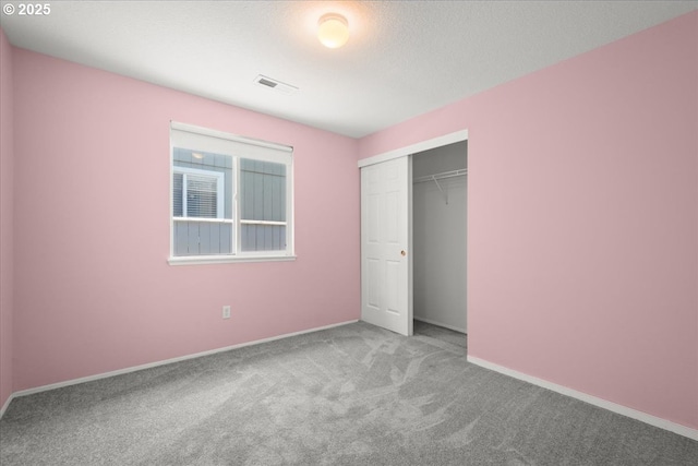 unfurnished bedroom featuring carpet, a closet, and baseboards