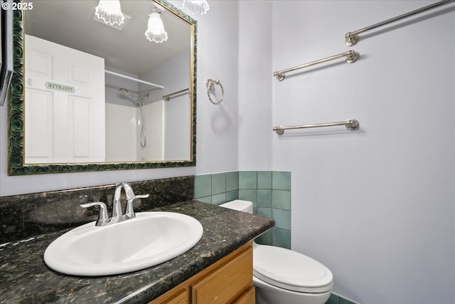 full bath with toilet, vanity, a shower, and tile walls