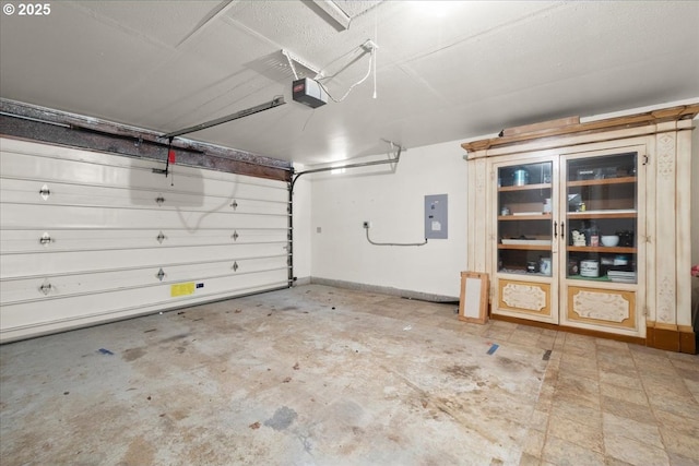 garage featuring a garage door opener, electric panel, and french doors
