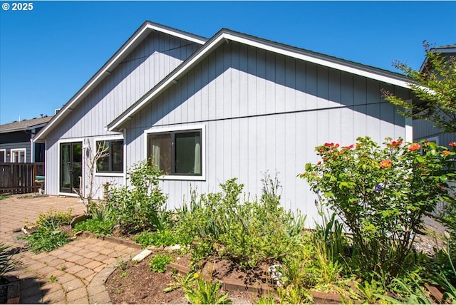 view of home's exterior featuring a patio and fence