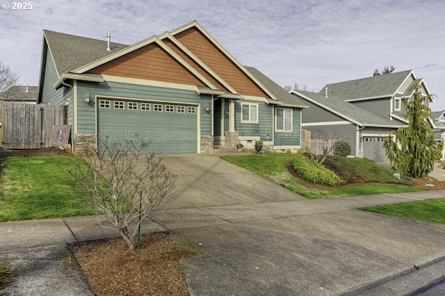 craftsman-style house with a garage, concrete driveway, stone siding, and fence