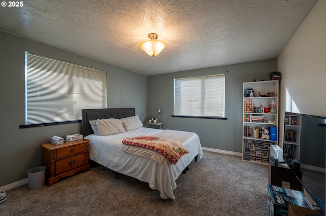 carpeted bedroom with a textured ceiling and baseboards