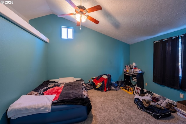 carpeted bedroom with lofted ceiling, a textured ceiling, and a ceiling fan