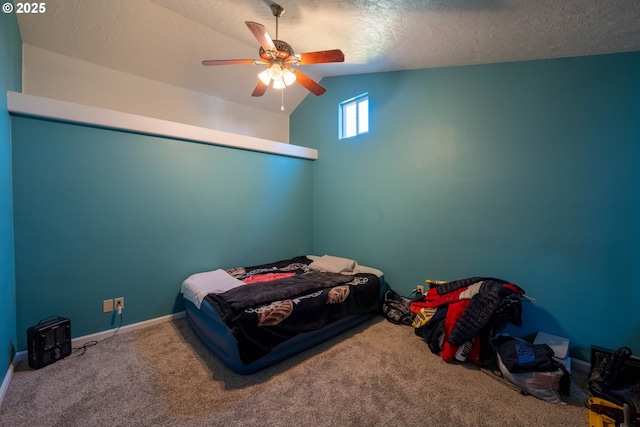 carpeted bedroom with lofted ceiling, ceiling fan, baseboards, and a textured ceiling