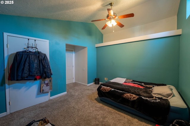 bedroom featuring carpet, a ceiling fan, vaulted ceiling, a textured ceiling, and baseboards