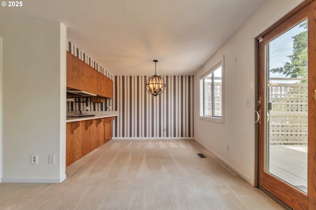 18005 SW Monte Verdi Blvd, Beaverton, OR 97007 - unfurnished dining area featuring a chandelier, light colored carpet, and baseboards