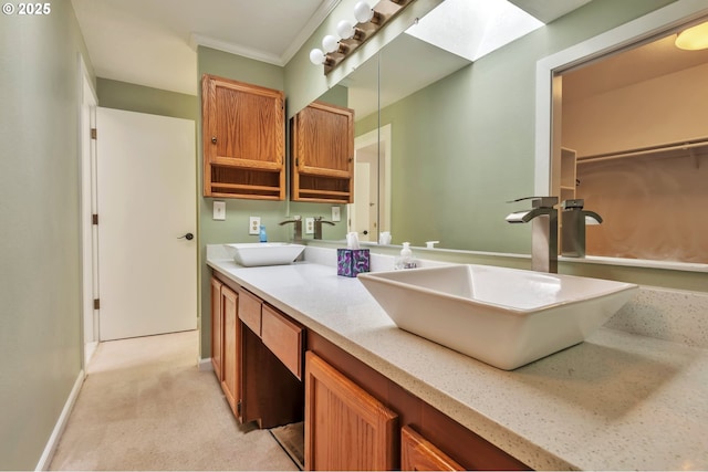 18005 SW Monte Verdi Blvd, Beaverton, OR 97007 - bathroom featuring double vanity, baseboards, ornamental molding, and a skylight