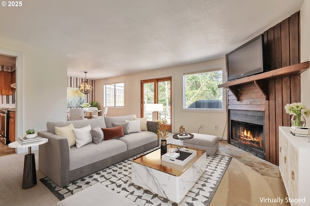 18005 SW Monte Verdi Blvd, Beaverton, OR 97007 - living area featuring plenty of natural light, a fireplace, a chandelier, and light colored carpet