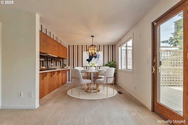 18005 SW Monte Verdi Blvd, Beaverton, OR 97007 - dining room with a chandelier, light carpet, and baseboards