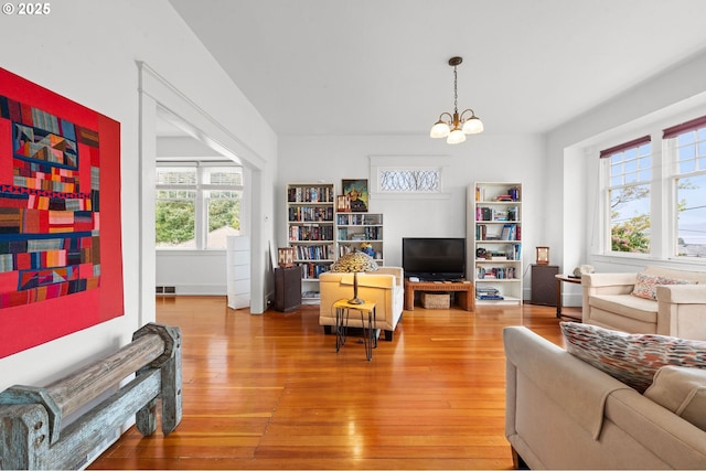 1219 Jerome Ave, Astoria, OR 97103 - living room with a chandelier and light wood-type flooring