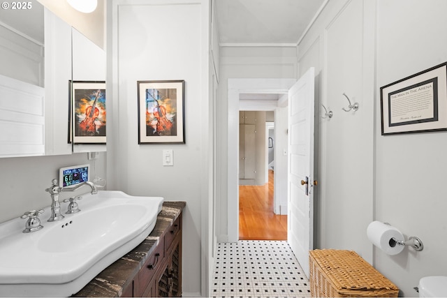 1219 Jerome Ave, Astoria, OR 97103 - half bath featuring tile patterned floors, vanity, and ornamental molding