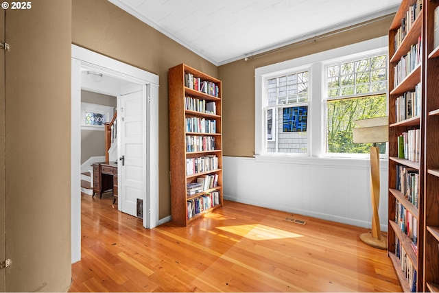 1219 Jerome Ave, Astoria, OR 97103 - living area with plenty of natural light, wood finished floors, stairway, and ornamental molding
