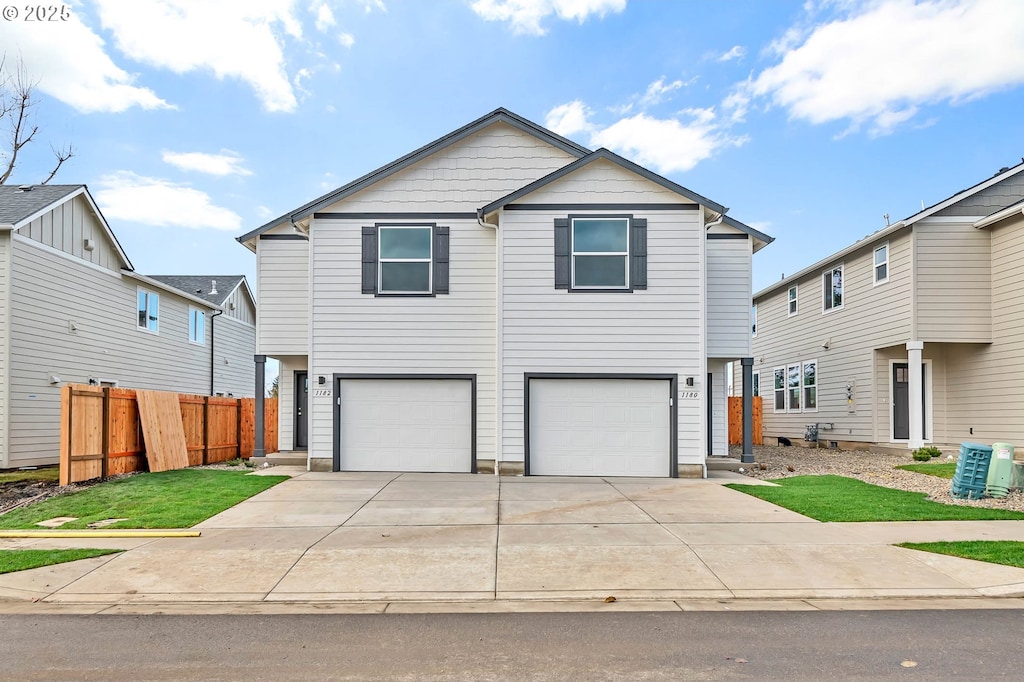 view of front of home with cooling unit, a garage, and a front lawn